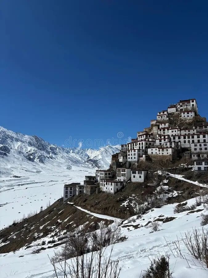 The whitewashed buildings of Key Monastery stacked up a hillside above the snow-covered Spiti valley