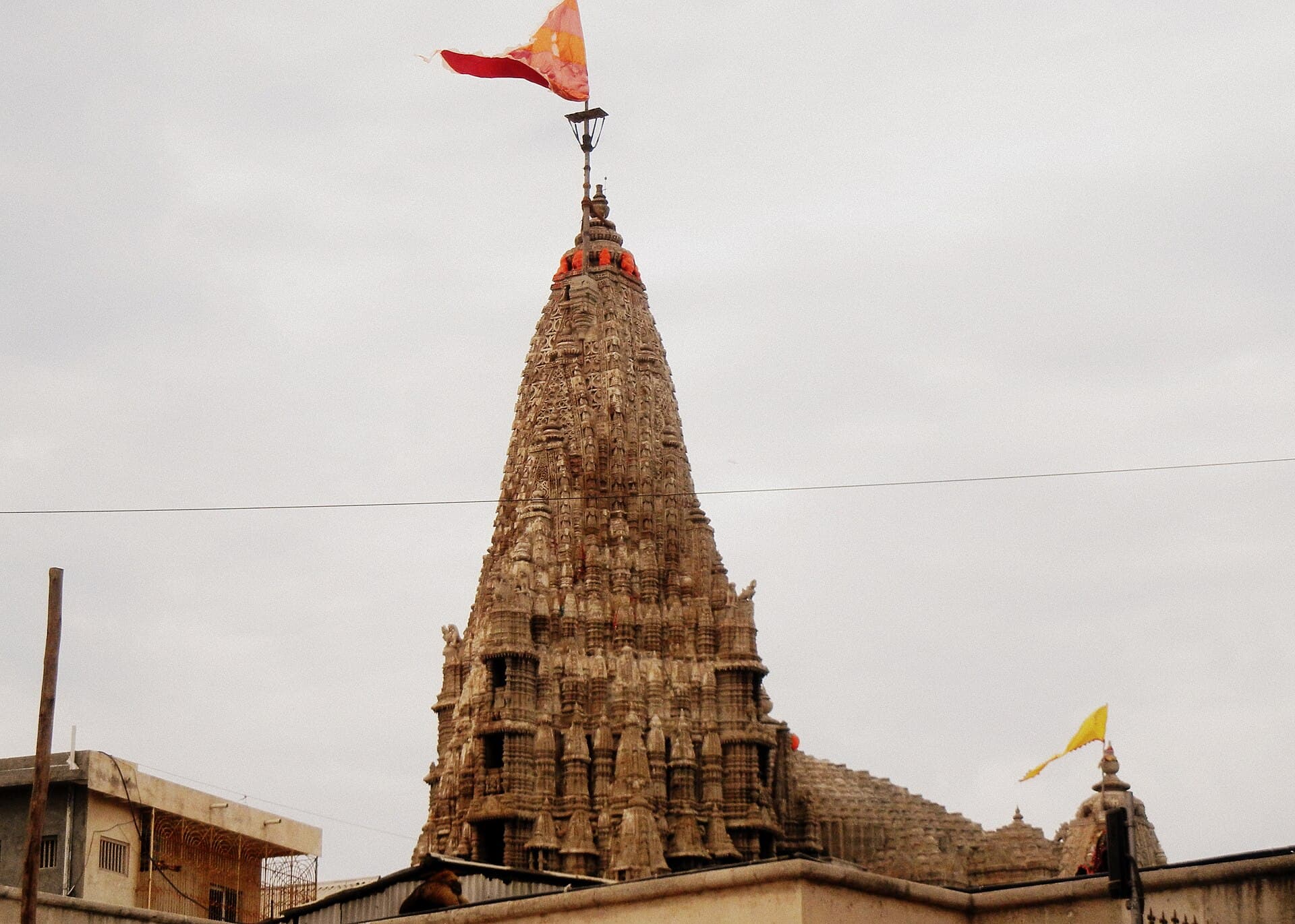 The carved stone spire and flag of the Dwarkadhish temple at Dwarka