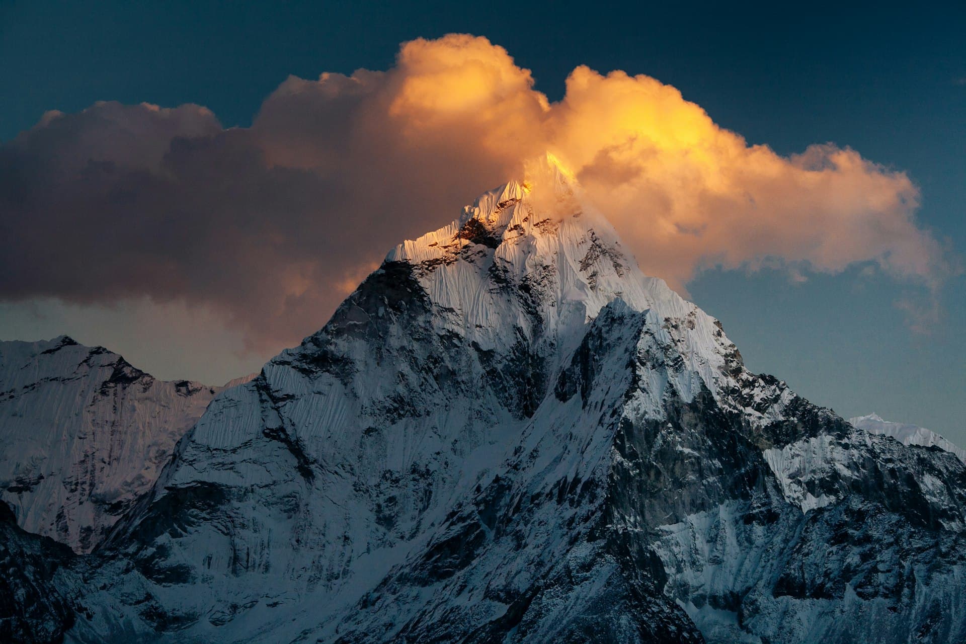 Sunset cloud lit gold above a Himalayan summit
