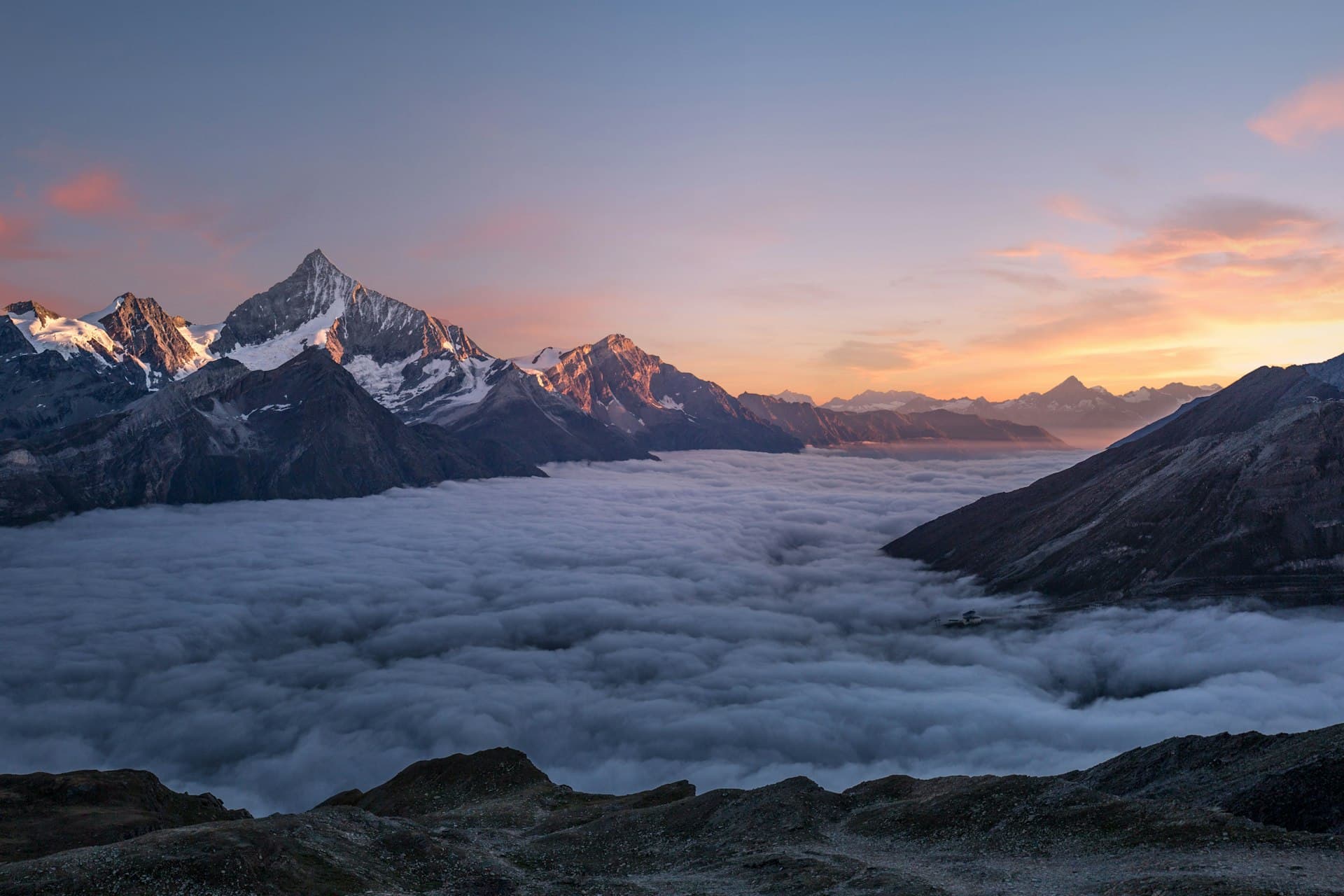 Himalayan peaks rising above a sea of cloud at dawn
