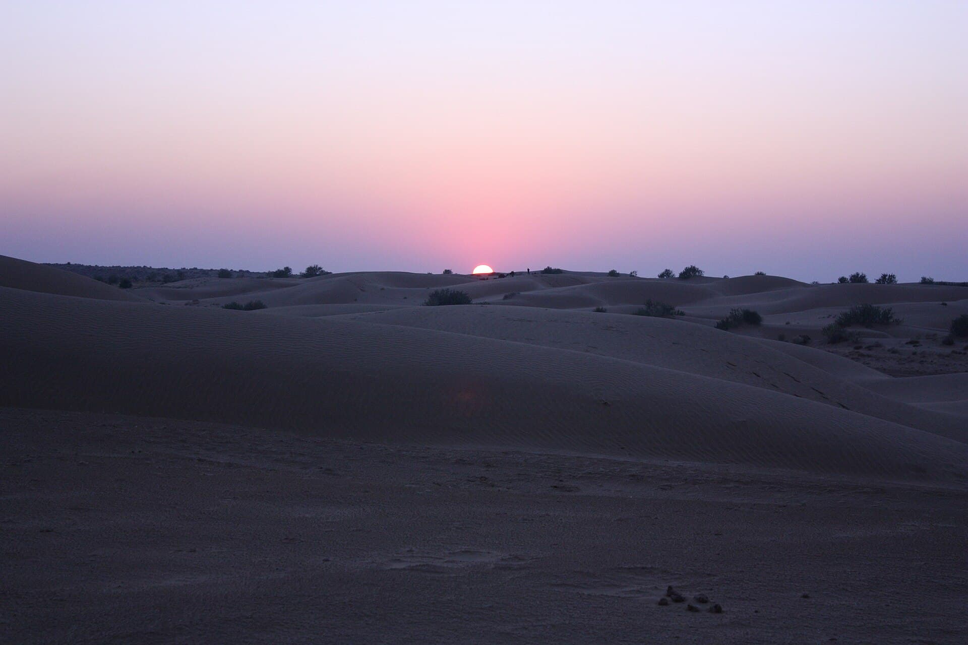The sun setting over rippled sand dunes in the Thar Desert near Jaisalmer