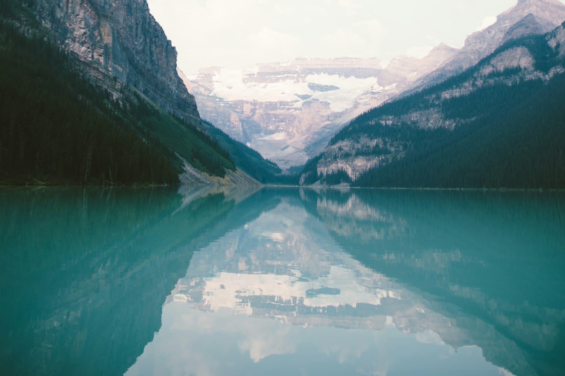 Still high-altitude lake mirroring the mountains around it