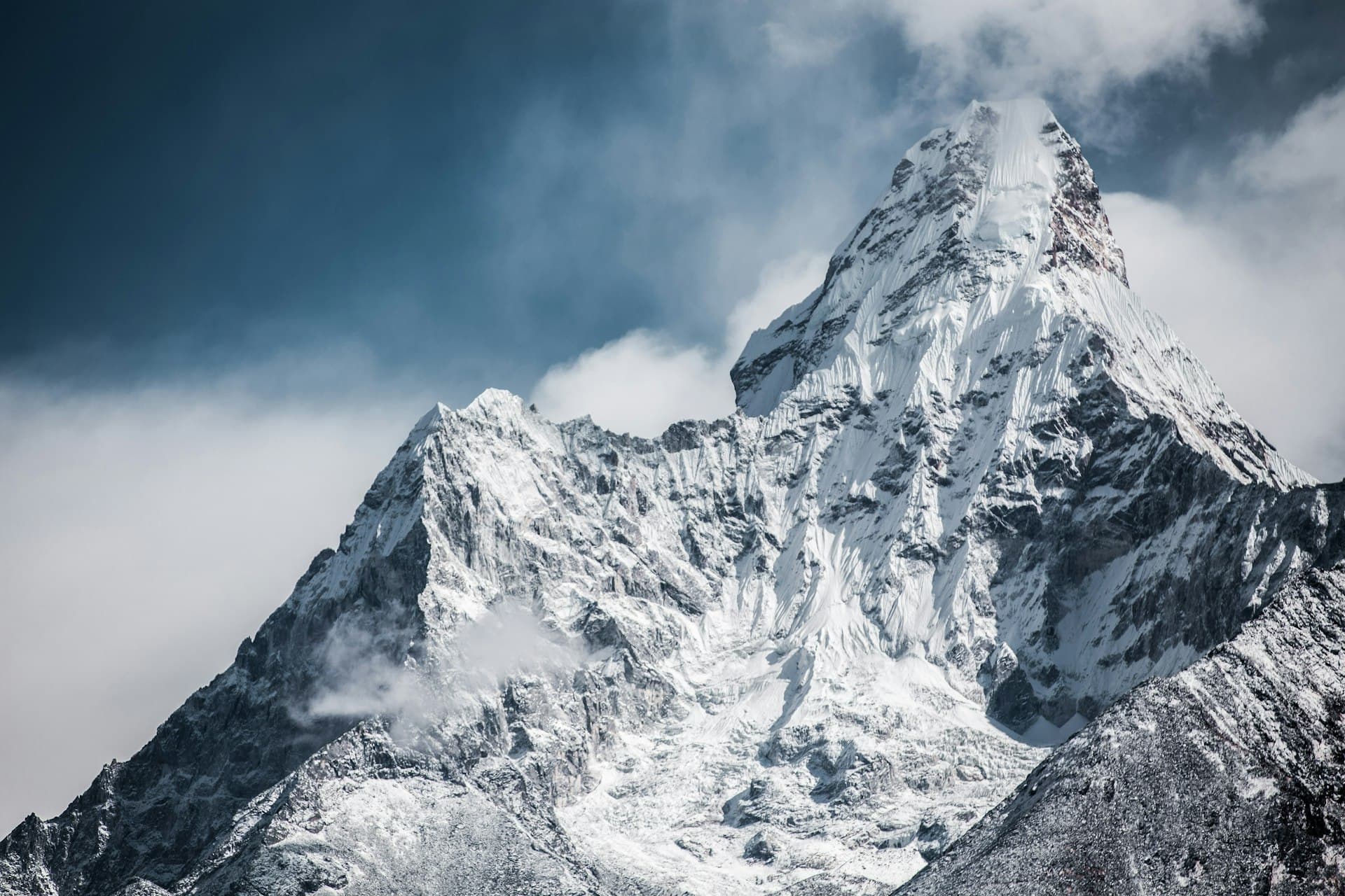 Sharp snow-covered summit against a dark Himalayan sky