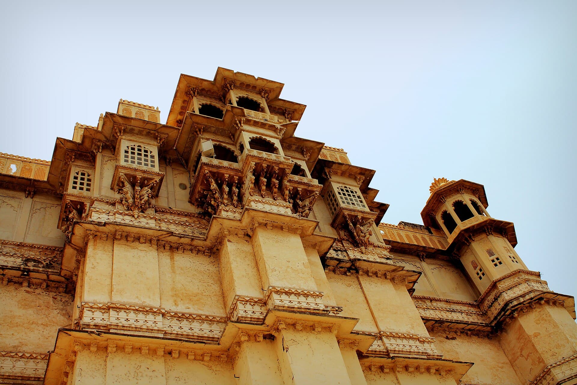 Carved balconies and domed turrets of the City Palace at Udaipur, seen from below